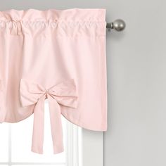 a pink bow tie valance hanging on the side of a window