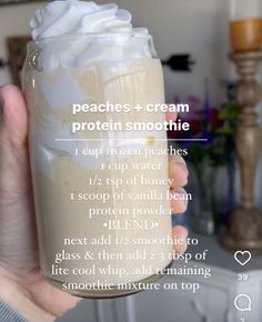 a person holding up a glass with whipped cream in it and instructions on how to use it