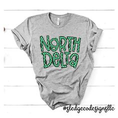 EXCLUSIVE: NORTH DELTA GREENWAVES POLKA DOTA | Custom Unisex Tshirt These are SOFT prints! No screen print and no vinyl! Made to Last! All our items are made to order. We print on the highest quality fabrics ranging from softstyle, Independent, Tulex, Royce Brand,Next Level, Comfort Colors, and many more! Almost all our items and designs are made in house.Designs are exclusively hand drawn or made in house for each team/school/item.As we continue to try to deliver our customers exclusive designs,we ask that our artwork is not to be copied.If you would like something drawn for you or your organization, pleaseReach out to us @ sledgecodesigns@gmail.com __________________________________________________________ FAQS | IN THE KNOW: Please allow 2-3 weeks for delivery, during busy seasons.We tr Green T-shirt With Letter Print For Outdoors, Green T-shirt With Letter Print For Outdoor Activities, Green Letter Print T-shirt For Outdoor Activities, School Spirit Wear, State School, Dress Appropriately, Spirit Wear, Co Design, Unisex Tshirt