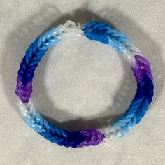 a blue and white bracelet on a white surface