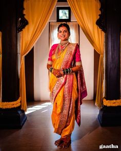 a woman in a yellow and red sari