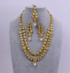 Featuring a gold-plated Meenakari necklace adorned with reverse AD and a maang tikka set, this versatile piece can be worn for any occasion. Style it with a neckline-flaunting dress or a saree to add sparkle to your overall look. Necklace can be adjusted with a doori. Jhumki Earring length: 2.5" with push-back closure Gold Polish on High-qality brass as the base metal Availability: In-Stock. *Color may vary slightly due to light condition & photography. Jewelry Care: Keep away from moisture. Allow perfumes and lotion to dry before wearing. Store in jewelry pouch. Clean only with soft lint free cloth. Maang Tikka Set, Meenakari Necklace, Contemporary Bracelets, Photography Jewelry, American Diamond Necklaces, Contemporary Necklace, Contemporary Earrings, Jhumki Earrings, Maang Tikka