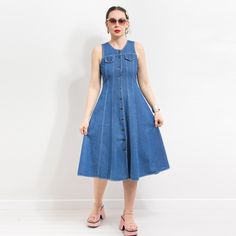 Vintage 90's sleeveless jean dress in blue - buttoned from top to bottom - materials: denim SIZE from the tag: 12 best fits women: M MEASUREMENTS bust: 36 inches (91 cm) waist: 31.5 inches (80 cm) hips: free length: 45.5 inches (116 cm) The model is 5'9" (174 cm), measures 35-27-38 (89-69-96 cm) and typically wears clothing in size M CONDITION - 9/10 - The dress in great pre-owned vintage condition. Washed, ready to wear. Vintage Knee-length Denim Dress For Summer, Fitted Sleeveless Denim Dress With Button Closure, Fitted Vintage Midi Denim Dress, Fitted Vintage Midi Length Denim Dress, Summer Denim Vest In Dark Wash With Button Closure, Summer Dark Wash Denim Vest With Button Closure, Fitted Sleeveless Denim Dress With Buttons, Sleeveless Dark Wash Denim Dress With Buttons, Fitted Medium Wash Denim Vest For Summer