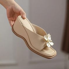 Step into summer with style and comfort with our Elegant Pearl Flower High Heel Wedge Slides. These chic wedge sandals are a must-have for any fashion-savvy woman looking to add a touch of elegance and sophistication to her warm-weather wardrobe. Designed with a thick bottom and adorned with a delicate pearl flower, these slides are not just stylish but also incredibly comfortable. Key Features High-Quality PU Upper: Durable and easy to clean, providing a sleek look. Comfortable Wedge Heel: Measures between 5cm to 8cm, perfect for enhancing posture without sacrificing comfort. Stylish Pearl Flower Accents: Adds a subtle glamour to your everyday outfits. Rubber Outsole: Offers excellent traction and durability. Adjustable Fit: Ideal for those with slightly wider or narrower feet. When to We Outdoor Platform, Flower Slippers, Summer Sandals Wedge, Slip On Wedge Sandals, Shoes Elegant, Elegant High Heels, Summer Wedges, High Heel Wedges, Womens Sandals Wedges