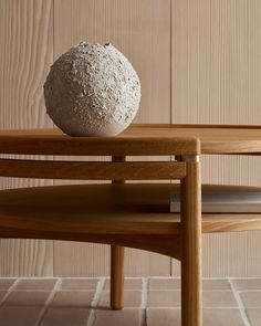 a white ball sitting on top of a wooden table