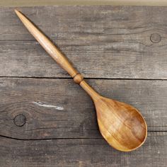 a wooden spoon sitting on top of a wooden table