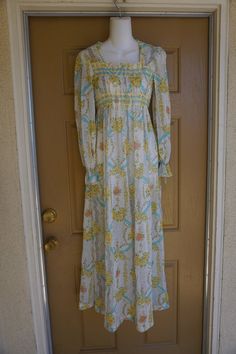 Prairie dress fits size 7. Zips in the back. Adjustable tie at waist. Sheer, would need to be worn with a slip.maker -Gunne Sax16" across front armpit to armpit13.5" across front of waist 58" length Retro Empire Waist Spring Dress, Vintage Flowy Maxi Dress, Flowy Vintage Maxi Dress For Daywear, 1970s Style Spring Maxi Dress, Retro Spring Maxi Dress For Daywear, 1970s Style Long Sleeve Maxi Dress For Summer, 1970s Style Long Sleeve Vintage Summer Dress, Vintage Flowy Maxi Dress For Garden Party, Retro Summer Maxi Dress For Daywear