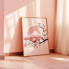 a painting on the floor in front of a pink wall with a mountain and cherry blossoms