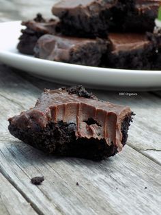 a white plate topped with brownies on top of a wooden table