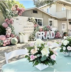 there are flowers on the table in front of the sign that says grandad and is decorated with balloons