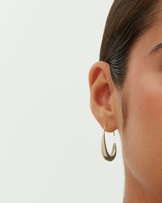 These exquisite pull-through teardrop earrings, measuring 24mm x 18mm with a 9mm opening, add an elegant touch to any look. Their distinctive shape and ideal size offer both style and comfort. Suited for any occasion, they enhance casual wear and elegantly complement dressy events, adding a touch of luxury at a great value. Materials 14K yellow gold or white gold plated. s925 Sterling Silver Posts. Measurements: Length: 24mm x 18mm; Opening: 9mm. Hypoallergenic; nickel, lead, and cadmium free. Modern Teardrop Drop Earrings Tarnish Resistant, Modern Teardrop Wrap Earring (single), Chic Metal Teardrop Drop Earrings, Chic Teardrop Pierced Earrings, Trendy Teardrop Earrings For Formal Occasions, Pear-shaped Hoop Earrings For Gifts, Modern Teardrop Wrap Earring, Chic Metal Teardrop Earrings For Formal Occasions, Trendy Formal Teardrop Earrings For Pierced Ears