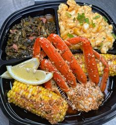 lobster, corn on the cob, and macaroni salad in a plastic container