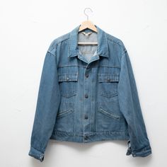 "Vintage denim jacket made for JC Penney, circa 1970s. Light blue \"Superdenim\" with brass snaps and gold topstitching.  Measurements no size tag - would fit a variety of sizes, small to large chest: 25\" bottom width: 24\" length (shoulder to hem): 23\" shoulder to shoulder: 22\" Materials: Superdenim fabric: 50% cotton, 50% denim  Condition notes: Overall good vintage condition, except for a two specks of black paint on the front. Tag is ripped." Vintage Denim Jacket, Black Paint, Vintage Denim, Size Tag, 1970s, Denim Jacket, Overalls, Light Blue, Jackets & Coats