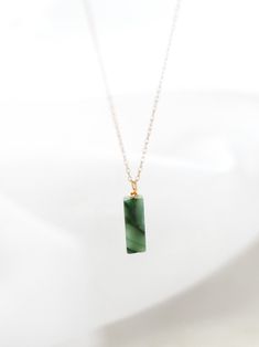 "Highlights * Made With 14k Yellow Gold Filled or Sterling Silver Pieces * Features a 13mm (About 1/2\") Round or Rectangle Genuine Jade Pendant * Available In 14\", 16\", 18\", 20\", 22\" Lengths About This Piece Our dainty jade necklaces are a great way to carry your most special moments with you! These simple and minimal necklaces are made to suit anyone and will last a lifetime. Our gemstones and their colors are authentic; they are not dyed or altered!" Jade Necklaces, Gemstone Bar Necklace, Vertical Bar Necklace, Minimalist Pendant, Minimal Necklace, Jade Gemstone, Gemstone Necklaces, Gold Bar Necklace, Personalized Pendant