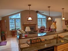 a large kitchen with an island in the middle and lots of counter space around it