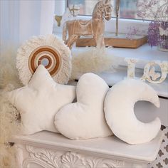 stuffed animals are sitting on a shelf in front of a window sill and other decorations