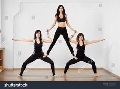 three women doing yoga poses with their arms in the air and one woman standing on her knees