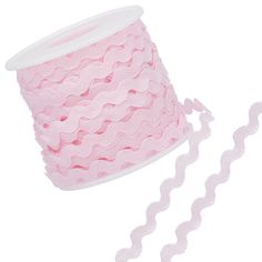 a spool of pink lace on a white background