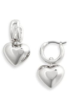 High-polished drop earrings have an innovative suspension design allowing the luminous heart to glide back and forth between the rails for subtle movement. 1/2" hoop diameter; 1" drop Snap-post closure 14k-gold plate Imported Elegant Heart Huggie Earrings For Everyday Wear, Elegant Everyday Huggie Earrings For Valentine's Day, Elegant Valentine's Day Huggie Earrings, Valentine's Day Polished Finish Earrings, Silver Huggie Earrings For Valentine's Day Elegant Style, Silver Huggie Earrings With Heart Charm For Anniversary, Elegant Silver Huggie Earrings For Valentine's Day, Polished Finish Heart Earrings For Gift, Silver Sterling Heart Charm Huggie Earrings