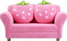 a pink couch with two large strawberry pillows on it's back and arms, sitting in front of a white background