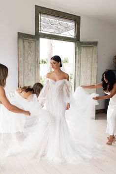 the bride is getting ready to walk down the aisle in her white wedding gown and veil