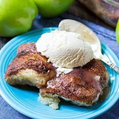 a blue plate topped with french toast and ice cream next to two green pears