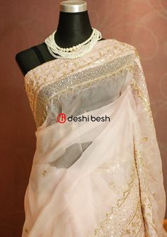 This exclusive boutique designer hand made Muslin saree is a perfect and unique choice for your occasional and party wear. Golden Motifs Embroidery, Sequences, Karchupi, and Tussles Work. Matching Running Blouse Piece. Color: There might be slight color variation due to lightings and flashes while photo shooting. The color may also vary because of different screen resolutions. Wash Care: Dry Clean Only. Note: This is a hand made boutique saree and could take 1 to 2 weeks longer than the estimate Designer Organza Pre-draped Saree With Dori Work, Diwali Pre-draped Saree With Chikankari Embroidery In Chinon, Party Pre-draped Saree With Chikankari Embroidery, Wedding Choli With Chikankari Embroidery In Tissue Silk, Reception Organza Traditional Wear With Chikankari Embroidery, Organza Traditional Wear With Chikankari Embroidery For Reception, Organza Chikankari Traditional Wear For Reception, Wedding Choli In Dola Silk With Chikankari Embroidery, Unstitched Tissue Silk Saree With Dori Work