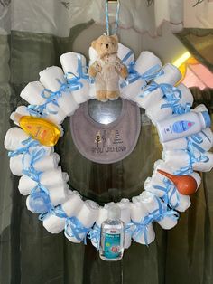 a baby shower wreath with a teddy bear on it