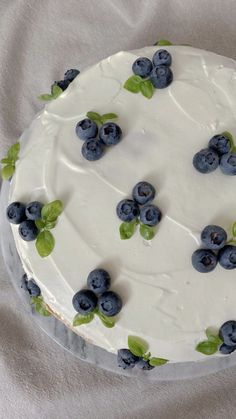 a cake with white frosting and blueberries on it