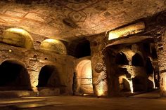 the interior of a cave with stone walls and arches