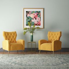 two yellow chairs sitting in front of a green vase filled with pink flowers on top of a rug