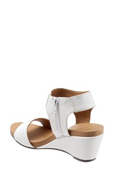 A wide, halter cuff enhances the contemporary appeal of this sleek wedge sandal. 2 3/4" heel Side zip closure Leather upper and lining/synthetic sole Imported Women's Shoes Summer Sandals With Zipper Closure And Round Toe, Spring Ankle Strap Sandals With Zipper, Spring Sandals With Zipper Closure, Spring Leather Sandals With Zipper Closure, Leather Low Heel Wedge Sandals With Arch Support, Low Heel Leather Wedge Sandals With Arch Support, Leather Wedge Sandals With Arch Support And Low Heel, Leather Open Toe Sandals With Zipper, Leather Open Toe Sandals With Zipper Closure