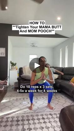 a woman is doing yoga in the living room with another woman sitting on her couch