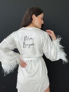 "Personalized White Silk and Feather Robe Chic robe made of silk with amazing feather trim on the sleeves. This robe is made to be a perfect gift for every bride on the most important morning of her life or as an outfit for relaxed bachelorette party or honeymoon. Can be made with a custom Mrs. or bought as is. *Please read all information below before placing your order:) 🤍ROBE INFO: - High quality silk and feather trim - True to size (model wears size M) - Feather trim on sleeves - White robe Bride Jacket, Wedding Robe, Feather Trim, White Feather, Bride Photo, Silk Robe, Bride Clothes, White Feathers, Wedding Weekend