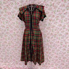 Lovely 50s Kay Windsor Original dress. Soft material in a red, black, and green buffalo plaid print. Large collar, short sleeves, a below the knee length hem, fit and flare silhouette, hook and loop brass front closure from the waist up and a side zip metal zipper closure. Some fading at one side of the neckline and collar, please see the photos. Would best fit a XS-S, but please see the measurements to ensure a perfect fit. Cute for Christmas or holidays but could work for other seasons as well! Original size is unknown. Material is estimated to be cotton. Here to help if you have any questions.  17.5 in chest 41 in length 29 in hips 13 in waist laid flat, please double where needed Vintage Dresses 50s, 50s Dresses, Buffalo Plaid, Red Green, Dress Clothes For Women, Fit And Flare, Knee Length, Red Dress, Vintage Ladies