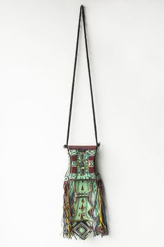 This purse was handcrafted by the nomadic Tuareg people who live in the Sahara Desert. Made from camel leather that has been naturally dyed with turquoise and purple pigments and then hand embroidered and beaded. Would make a beautiful wall hanging. Great condition 15" long from top to bottom Box measure 4.25 x 5 x 1 inches All clearance items are final sale Artisan Hand-tooled Shoulder Bag For Festivals, Artisan Leather Shoulder Bag For Festival, Bohemian Pouch Shoulder Bag With Hand-stitched Details, Bohemian Hand-stitched Bags, Artisan Hand-stitched Festival Bags, Traditional Hand Tooled Bag For Festivals, Traditional Hand-tooled Bag For Festivals, Bohemian Leather Shoulder Bag With Hand-stitched Details, Bohemian Hand-stitched Pouch Shoulder Bag