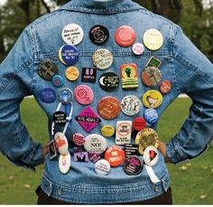 a person wearing a jean jacket with buttons on it