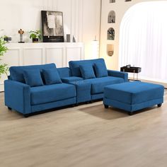 a blue couch and ottoman in a living room