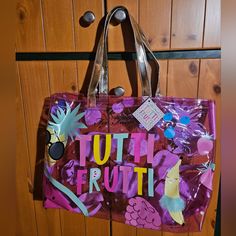 a handbag hanging on a door with the words tutti frutti printed on it