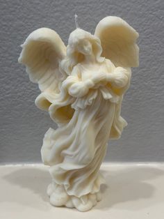 an angel figurine is shown on a table