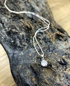 Our .925 Sterling Silver Cubic Zirconia necklace is as brilliant as the real thing!  Made with a .75 Carat brilliant cut CZ and .925 Sterling Silver components and chain.  Your choice of 16", 18", 20", 22" or 24" Sterling Silver Chain length.  Round CZ pendant is approximately 6mm in diameter. Dimensions are approximate and sizes or colors may vary slightly due to the characteristics of handmade products.  Please verify the correct shipping address before making your payment. If we ship your item to an old or invalid address and you are not able to locate the item, we are not responsible for shipping a replacement. Please review our Shop Policies page before purchasing: https://www.etsy.com/shop/BulletDesigns#policies Thanks! We appreciate you stopping by our shop! Silver Cubic Zirconia Solitaire Necklace Gift, Silver Solitaire Necklace With Diamond Cut In Sterling Silver, Cubic Zirconia Necklace With Prong-set Round Pendant, Dazzling Silver Solitaire Necklace With Diamond Accents, Silver Sterling Solitaire Necklace, Dazzling Silver Solitaire Pendant Necklace, Silver Pendant Jewelry With Brilliant Cut, Silver Necklace With Round Stone For Wedding, Silver Diamond Necklace With Round Stone For Wedding