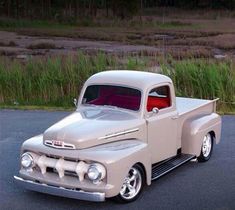 an old pick up truck parked in a parking lot