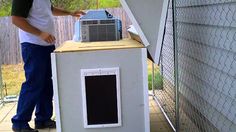 a man standing next to a small air conditioner on top of a wooden box