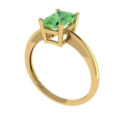 a yellow gold ring with an emerald stone