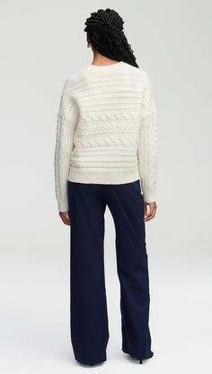 Get wrapped up in this carefully crafted chunky sweater made from 100% merino wool. The soft sweater has a cropped, boxy silhouette and a timeless cable pattern that runs horizontally. Pair this chilly weather must-have with denim for a weekend look or dress it up for the work week with trousers and heels.