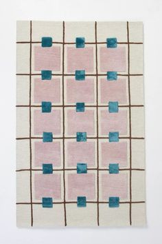 a pink and blue rug with squares on it