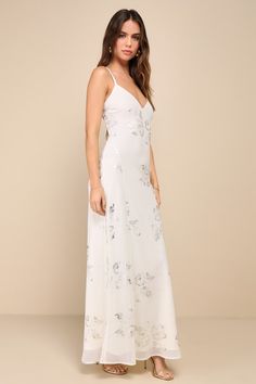 Your beauty will wow wherever you go in the Lulus Blissfully Graceful Ivory Floral Metallic Backless Maxi Dress! Lightweight woven chiffon boasts an elegant, metallic floral print as it shapes slender straps that tie across the open back. Bodice has a V-neckline and a flattering waist, atop a slip-style skirt finishes at a maxi hem. Fit: This garment fits true to size. Length: Ankle length. Size medium measures 58.5" from adjustable straps to hem. Bust: Great for any cup size. Waist: Loosely Fit Glamorous Floral Print Maxi Dress For Wedding, Summer Wedding Maxi Dress With Sequins, Glamorous Chiffon Maxi Dress For Wedding, White Chiffon Gala Dress, White Floral Print Maxi Dress For Gala, White Glamorous Maxi Dress With Fitted Bodice, Elegant Bridesmaid Maxi Dress With Sequins, Elegant Sequined Bridesmaid Maxi Dress, Sequin Maxi Dress For Wedding Guests