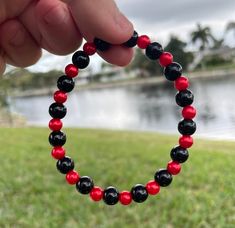 A beautiful black & red bracelet to wear or to gift to men/women. Black Bangle Stretch Bracelet Gift, Black Bangle Stretch Bracelet As Gift, Black Bangle Bracelet As A Gift, Red Stretch Bracelet With Black Beads, Handmade Black Stretch Bangle Bracelet, Red Stretch Bracelet With Black Beads As A Gift, Black Hand-strung Bangle Bracelets, Red Hand-strung Bangle Bracelet, Hand-strung Black Bangle Bracelets