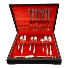 a set of silverware in a red case