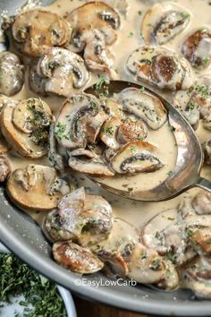 a pan filled with mushrooms and sauce